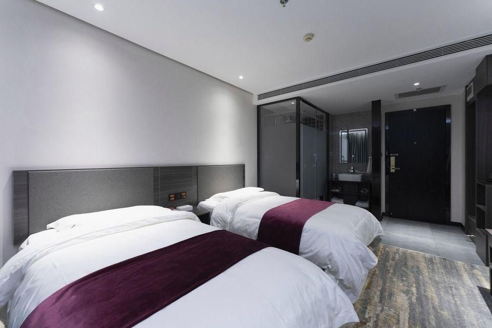 Qindao Business Hotel - زيان - غرفة نوم