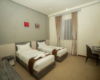 Green Rose Hotel - Lubuk Baja - Schlafzimmer