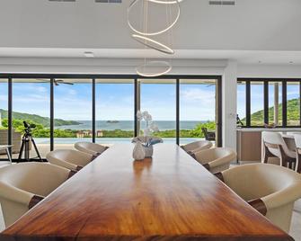 Discover coastal living at its finest in this exquisite three-bedroom home. - Playa Hermosa - Dining room