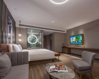 Orange Hotel Heze Zhongbei Xinduxin - Heze - Camera da letto