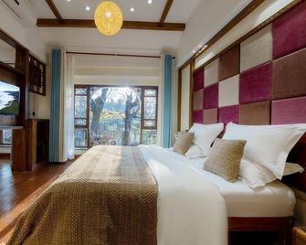 Jiuqi Fuxiang Inn (Lijiang Ancient City Dashuiche Branch) - Lijiang - Bedroom