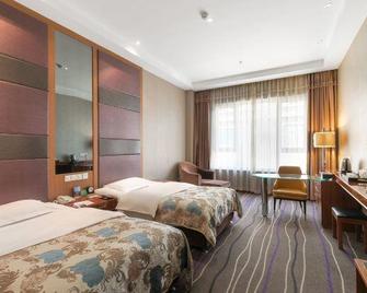 Xinfusheng Yihai International Hotel - Qingdao - Bedroom