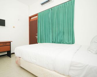 Merapi Inn Syariah - Surabaya - Schlafzimmer