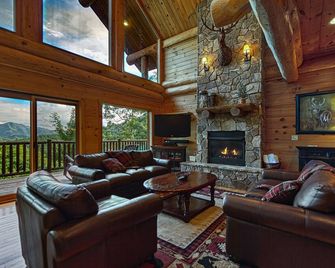 Antler Ridge - a stunning log cabin with spacious deck equipped with outdoor fireplace, hot tub, and scenic mountain views! - Almond - Living room