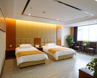 Double Dragon Holiday Hotel(Anqing Railway Station) - Anqing - Slaapkamer