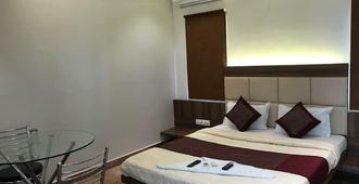 Hotel Rakshit International - Belgaum - Bedroom