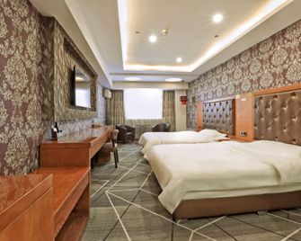 Dingyi Business Hotel (Harbin Dolphin Castle Hot Spring Water Park Branch) - Harbin - Habitación