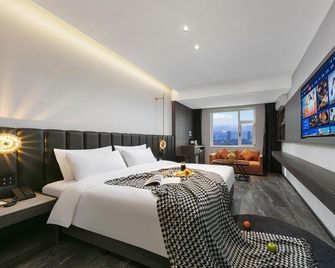 Manyi Hotel (Jincheng people's square international trade shopping center store) - Jincheng - Slaapkamer