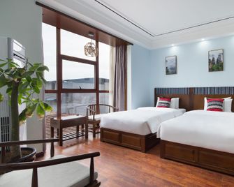 Zhangjiajie Debao Boutique Hotel - ג'אנגג'יאיי - חדר שינה