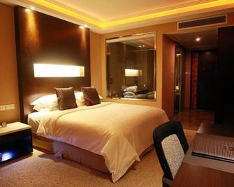 Jundu Center Hotel Yantai - Янтай - Спальня