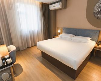 Home Inn Harbin Sanda Dongli Road Haguo - Harbin - Habitación