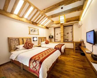 Zhangjiajie Wangyi Inn - ג'אנגג'יאיי - חדר שינה