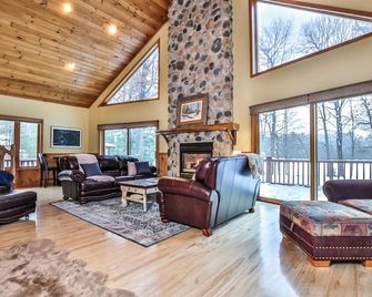 Large lakeside home with hot tub, gazebo, dock, firepit, and fenced in yard! - Saint Germain - Living room