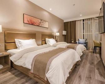 Jinjiang Metropolo Hotel Qingdao Xinduxin Capitaland Plaza - تشينغداو - غرفة نوم