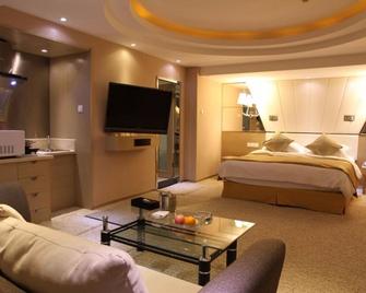 The Center Grand Hotel - ยานไถ - ห้องนอน
