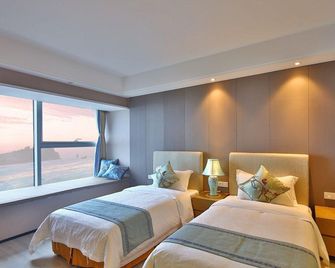 Lvfeng Yage Holiday Apartment (Qingdao Convention and Exhibition Center) - Qingdao - Makuuhuone
