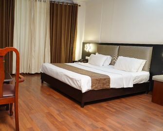 Malanadu Tourist Home - Kanhangad - Schlafzimmer
