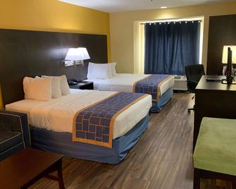 Days Inn & Suites by Wyndham Tampa / Raymond James Stadium - Tampa - Bedroom
