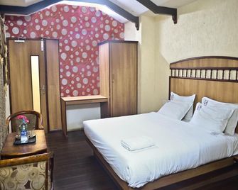 SS Hotels - Tiruppur - Schlafzimmer