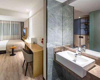 Wenrun Zhixing Holiday Hotel Nanjing Aoti Jiangdong Middle Road - Nanjing - Bedroom