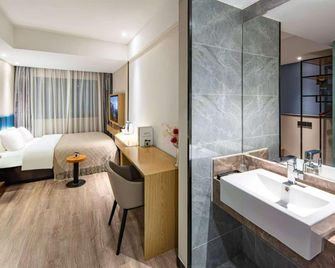 Wenrun Zhixing Holiday Hotel Nanjing Aoti Jiangdong Middle Road - נאנז'ינג - חדר שינה