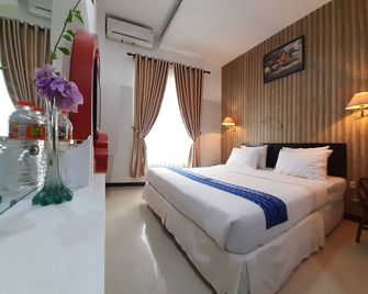 Queen City Hotel - Банджармасін - Спальня