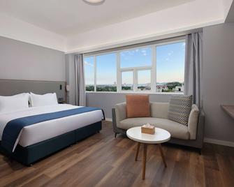 رامادا إنكور باي ويندام تشينجداو شينان - تشينغداو - غرفة نوم