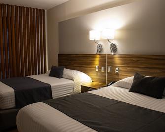 إستانزا هوتل آند سويتس - موريليا - غرفة نوم