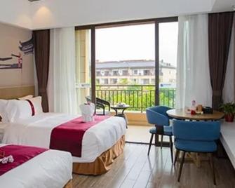 Golden Stone Business Hotel - Wanning - Ložnice