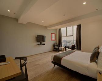 Shagun Hotel - ואדודרה - חדר שינה