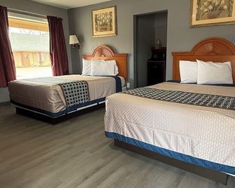 Budget Inn - Magnolia - Schlafzimmer
