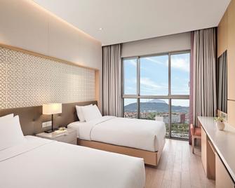 لاندينغ جيجو شنوا وورلد هوتلز آند ريزورتس - سيوغويبو - غرفة نوم