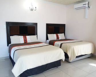 جلوبال فيلادج جست هاوس - مانزيني - غرفة نوم