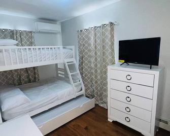 “Charming Family-Friendly Home in a Peaceful Neighborhood- With Pool - Queens - Bedroom