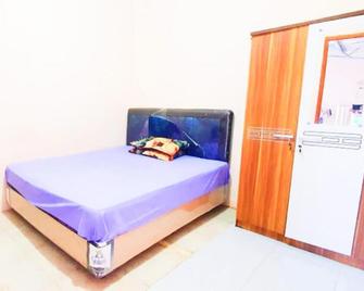 Green Kanca Syariah Guest House Mitra RedDoorz - Pasuruan - Slaapkamer