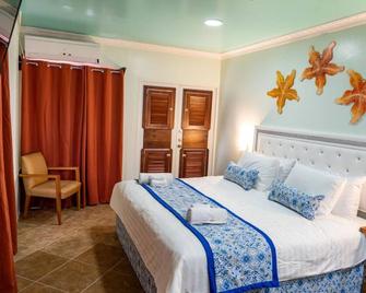 Island Magic Beach Resort - Caye Caulker - Schlafzimmer
