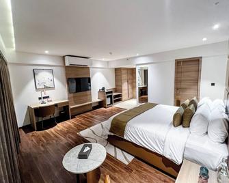 Oshin Calicut - Kozhikode - Schlafzimmer