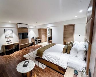 Oshin Calicut - Kozhikode - Schlafzimmer