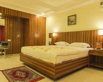 Hotel Green Park Suites - Manipala - Schlafzimmer