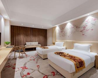 New Plum Garden Seasons Hotel - Shenzhen - Schlafzimmer