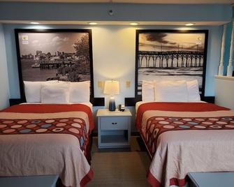 Coastal Inn & Suites - Wilmington, Nc - ווילימינגטון - חדר שינה