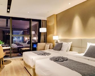 Yanbian Huayi Kailos Hotel - Yanbian - Bedroom