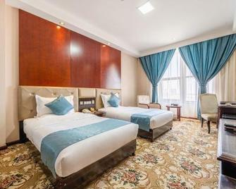 Longteng Hotel - جيوتشيوان - غرفة نوم