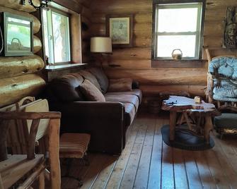 Dearborn River Log Cabin with 3/4 mi River Frontage & 72 Acres to Roam - Cascade - Living room