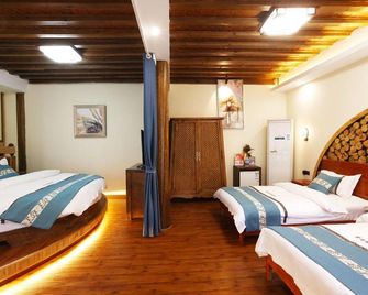 Ziguang Ruijingna Boutique Inn - ליז'יאנג - חדר שינה
