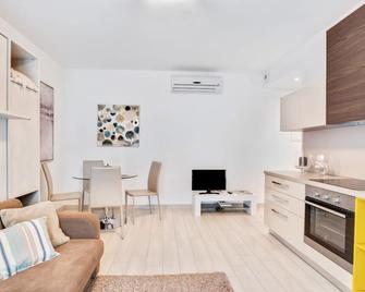 Brand new apartment located in Cernobbio, a charming town on the shores of Lake Como! The area is elegant and residential, with 3 big supermarkets nearby, as well as pharmacies, bars and restaurants! Bus stop heading to Como and Menaggio at 550m from the - Cernobbio - Living room