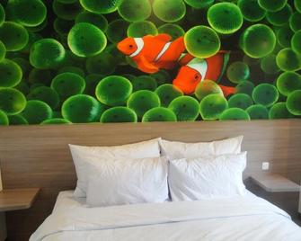Top Hotel Manado by Gran Puri - Манаго - Спальня