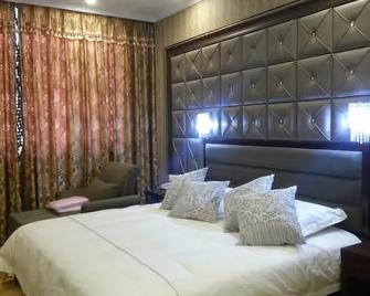 Jinxiu Jinhua Hotel - Turpan - Bedroom