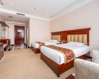 Wuhu Holiday Hotel - Zhangye - Schlafzimmer