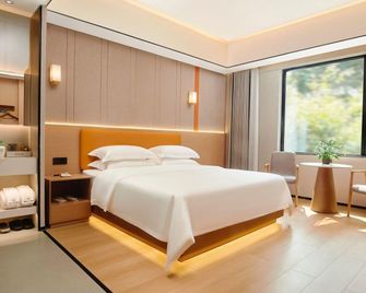 Junyue Sanjiang Theme Hotel Mianyang - Mianyang - Camera da letto